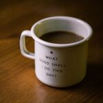 Coffee cup with the words "what good shall I do this day?"